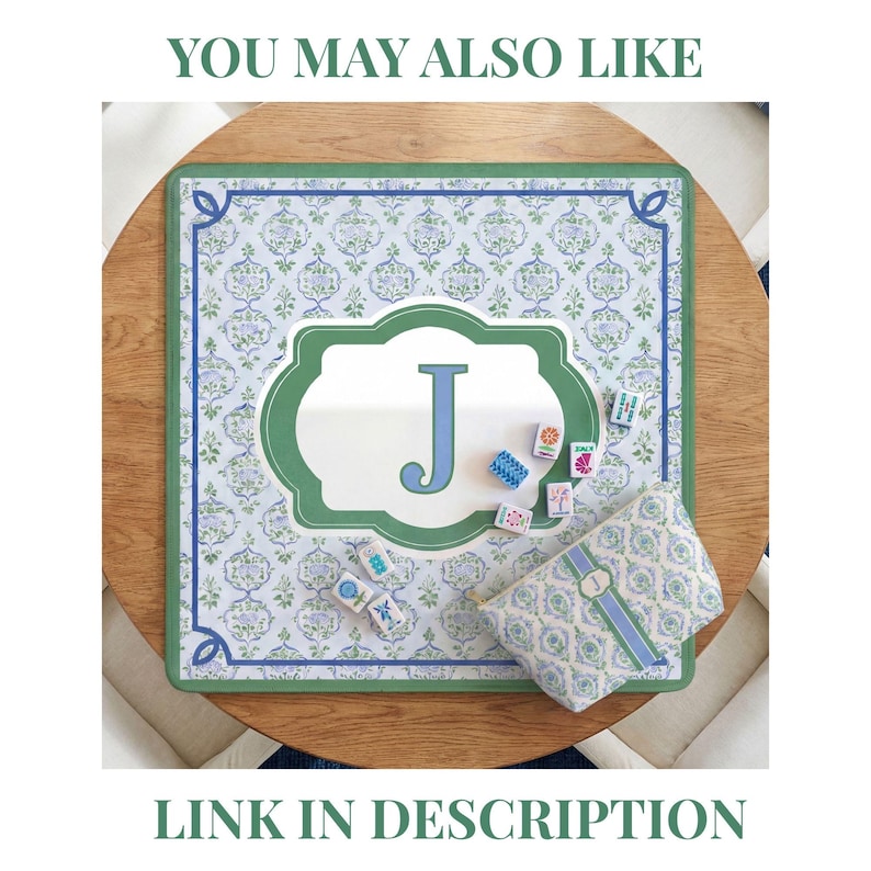 May include: A decorative mat with a green border and a floral pattern, featuring a large letter "J" in a green and white frame. A matching pouch and game tiles are also present. The text "YOU MAY ALSO LIKE" and "LINK IN DESCRIPTION" are visible.