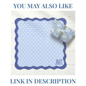 May include: A light blue polka dot notepad with a scalloped edge and the initials "JMT". A matching floral print gift is also present. The text "YOU MAY ALSO LIKE" and "LINK IN DESCRIPTION" are displayed in blue.