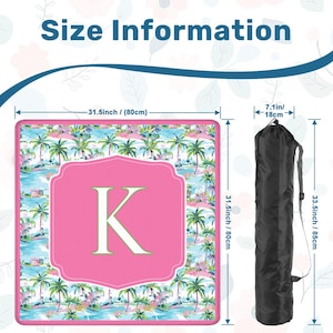 May include: A beach mat with a tropical palm tree design, measuring 31.5 inches (80cm) square, with a pink central panel featuring the letter "K". Includes a black carrying bag, 33.5 inches (85cm) long.