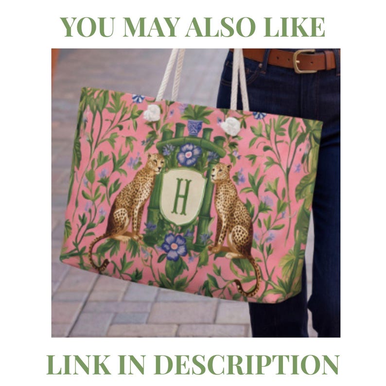 May include: A rectangular tote bag with white rope handles featuring a pink background with a green botanical pattern, two leopards, and a central crest displaying the letter H. The text YOU MAY ALSO LIKE and LINK IN DESCRIPTION is visible.