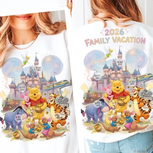 May include: White sweatshirt featuring a colorful graphic of Winnie the Pooh and friends in front of a castle, train, and fireworks. Text on the back reads "2026 Family Vacation". The design includes the text "DO NOT COPY" in several places.