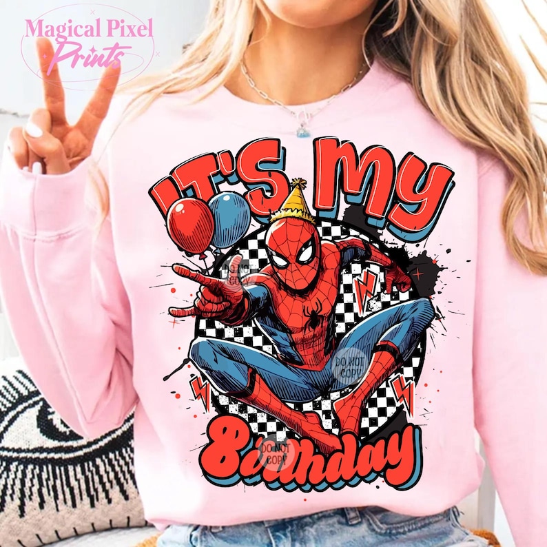 May include: Pink sweatshirt with a graphic of Spiderman wearing a party hat and holding balloons. The text "It's My Birthday" is printed in red and white.
