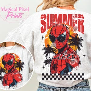 May include: A white sweatshirt with a graphic print of Spiderman wearing sunglasses and a palm tree background. The text "Summer Vibes" is printed on the sweatshirt.