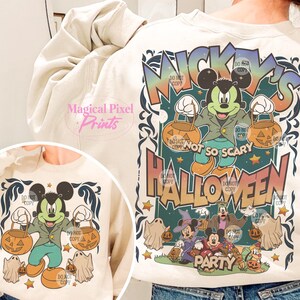 May include: A cream-colored sweatshirt with a graphic print of Mickey Mouse dressed in a green jacket and blue pants holding pumpkins. The text "Mickey's Not So Scary Halloween Party" is printed on the sweatshirt.