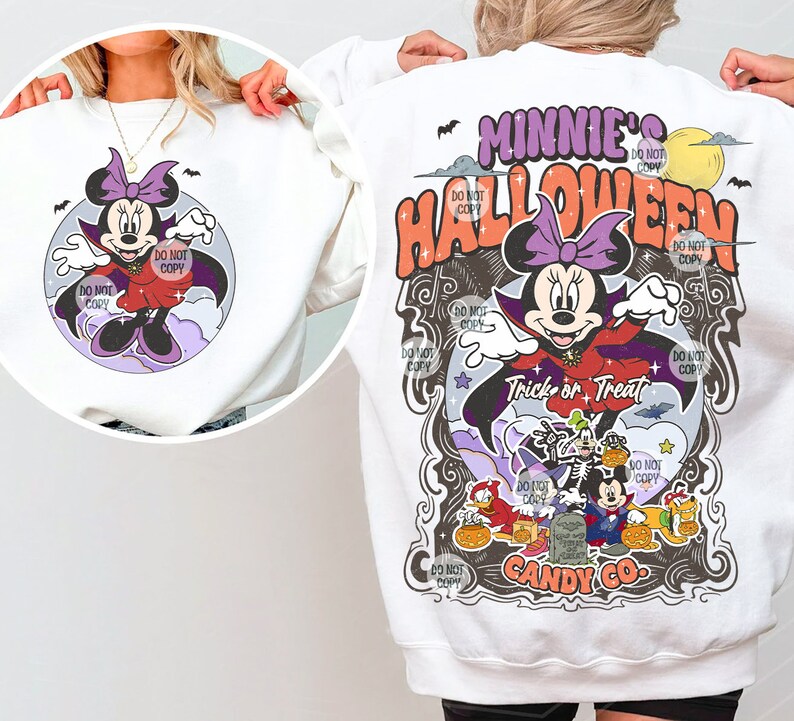 May include: White sweatshirt with a graphic print of Minnie Mouse dressed as a vampire with the text "Minnie's Halloween Trick or Treat Candy Co."