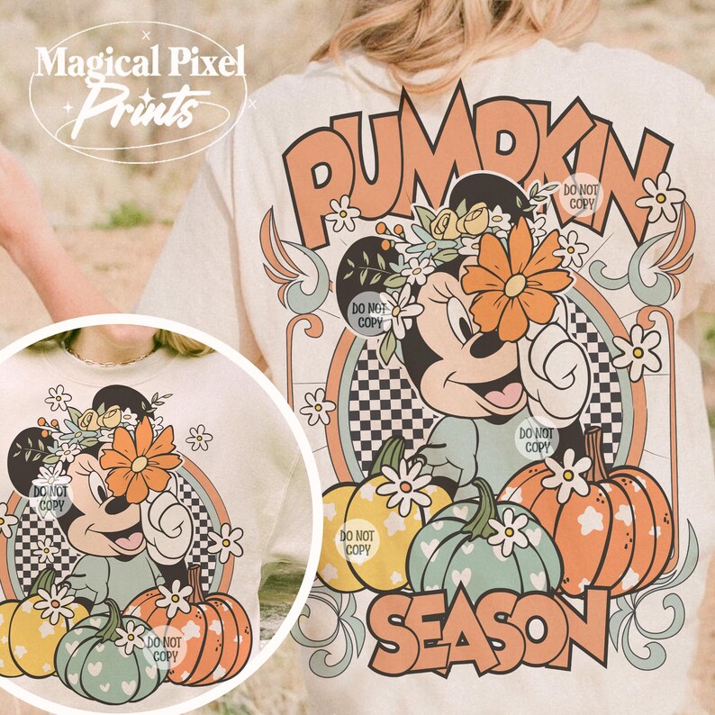 May include: A beige t-shirt with a vintage-style graphic featuring a cartoon mouse wearing a flower crown and holding a large orange flower. The graphic also includes pumpkins, flowers, and the text "Pumpkin Season".