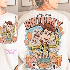 May include: White sweatshirt with a cartoon image of Woody from Toy Story. The image includes a birthday cake, presents, and balloons. The text "It's my Birthday" is printed in pink letters on the sweatshirt.