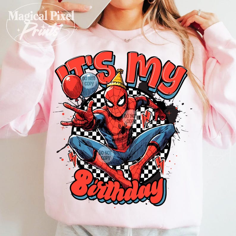 May include: Pink t-shirt with a graphic of Spiderman in a red and blue suit with a party hat. The graphic also includes the text "It's My Birthday" in a colorful font.