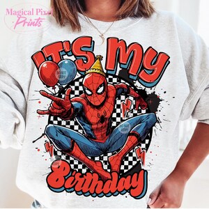 May include: A white sweatshirt with a red, blue, and black graphic of Spiderman. The graphic says "It's my birthday" in a retro font.