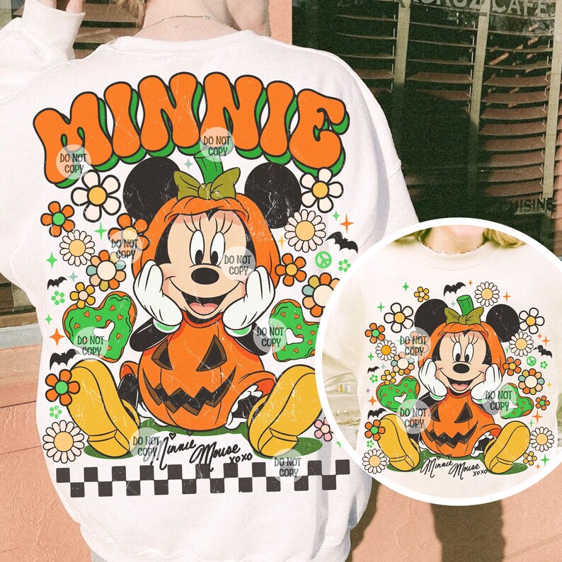 May include: White sweatshirt featuring a retro design with the word "MINNIE" in orange and green. The graphic includes Minnie Mouse dressed as a pumpkin, surrounded by flowers, bats, and the text "Do Not Copy".