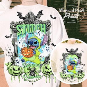 May include: White sweatshirt featuring a Halloween-themed graphic. The design includes the word "STITCH" in green, a cartoon character holding a pumpkin, ghosts, and the words "Spooky Season". Bats and green pumpkins complete the design.