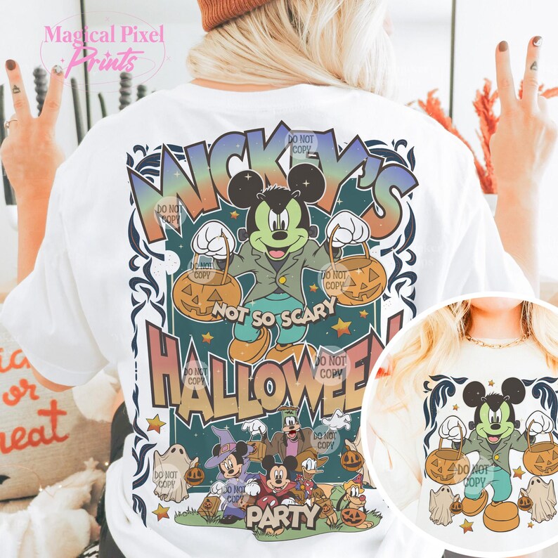 May include: White t-shirt with a colorful graphic of Mickey Mouse and friends celebrating Halloween. The graphic says "Mickey's Not So Scary Halloween Party".
