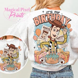 May include: A white sweatshirt with a cartoon image of Woody from Toy Story. The image includes a birthday cake, presents, and the text "It's my birthday".