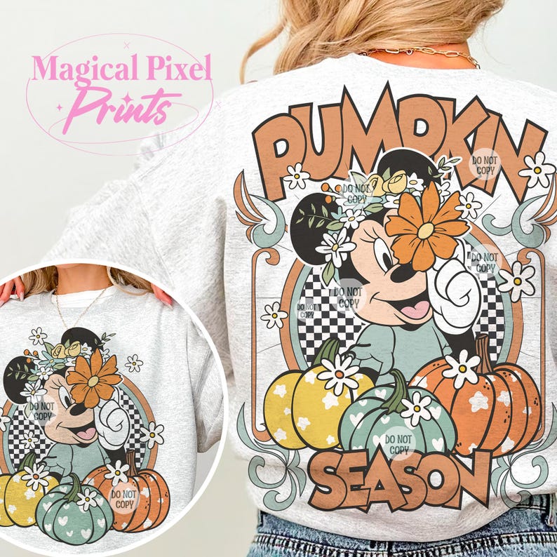 May include: A white sweatshirt with a graphic print of a cartoon mouse wearing a flower crown and holding a pumpkin. The graphic also includes the text "Pumpkin Season" and a checkered pattern.