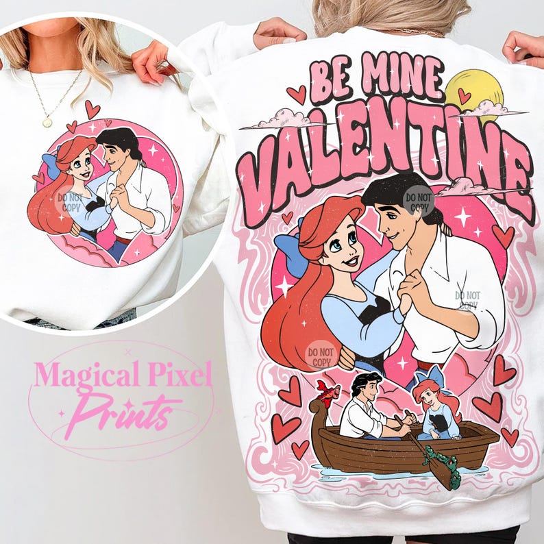 May include: White sweatshirt with a pink graphic print of Ariel and Prince Eric from The Little Mermaid. The graphic includes the text "Be Mine Valentine" with hearts and stars.
