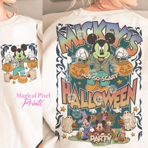 May include: A white sweatshirt with a colorful graphic print of Mickey Mouse dressed in a green jacket and holding a pumpkin bucket. The text "Mickey's Not So Scary Halloween Party" is printed in a vintage style font.