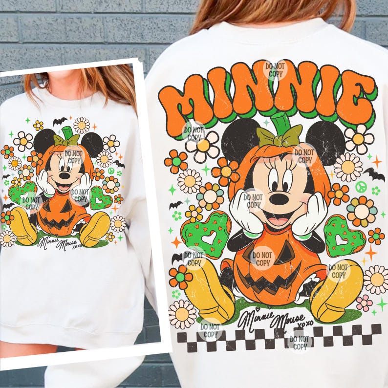 May include: White sweatshirt featuring a Halloween-themed Minnie Mouse design. Minnie is depicted inside a jack-o'-lantern, surrounded by flowers, hearts, and bats. The word "MINNIE" is arched across the top in orange and green. The text "Minnie Mouse xoxo" is at the bottom.