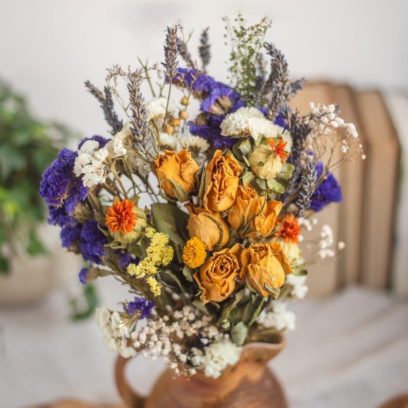 Yellow rose bouquet with lavender, statice, gypsophila and carthamus.