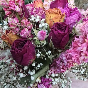 5 different colours and varieties of roses, peonys and nigela wrapped in gypsophia.