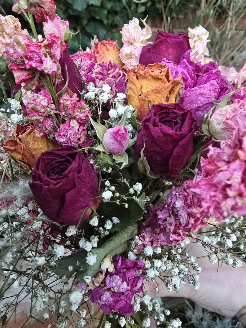 5 different colours and varieties of roses, peonys and nigela wrapped in gypsophia.