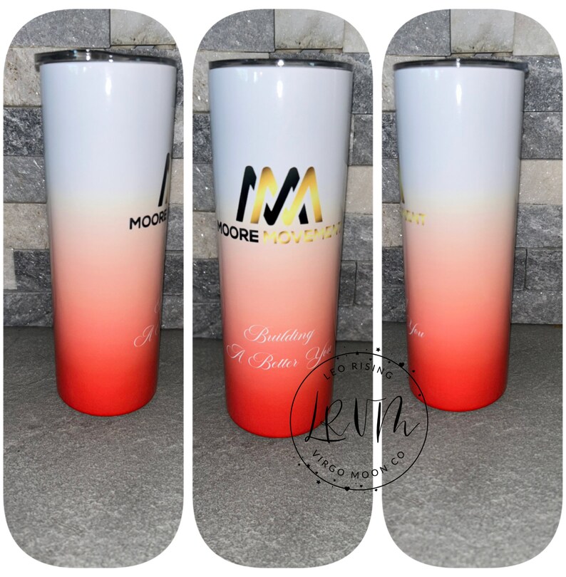 May include: A white and red ombre tumbler with a gold logo that says "Moore Movement" and the text "Building You A Better You". The tumbler also has a gold logo that says "Leo Rising Virgo Moon Co."