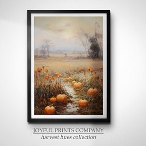 May include: A framed painting depicting a field with a stream running through it. The field is filled with orange pumpkins and the background is a hazy, muted landscape. The painting is titled "harvest hues collection" by Joyful Prints Company.