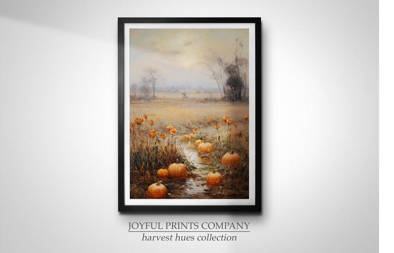 May include: A framed painting depicting a field with a stream running through it. The field is filled with orange pumpkins and the background is a hazy, muted landscape. The painting is titled "harvest hues collection" by Joyful Prints Company.