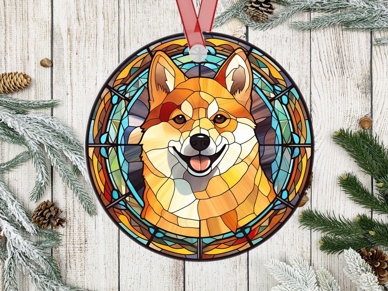 May include: A stained glass ornament featuring a Shiba Inu dog with a colorful background. The dog is depicted in a circular frame with a stained glass design.