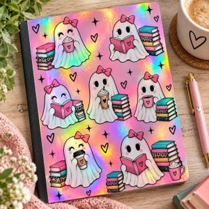 May include: A holographic notebook cover featuring a repeating pattern of cartoon ghosts wearing pink bows. Each ghost is either reading a book or holding a coffee cup, accompanied by stacks of colorful books, small black hearts, and star icons.