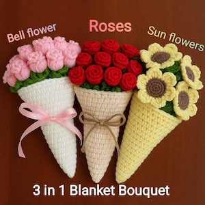 May include: Three crocheted flower bouquets: bell flowers, roses, and sunflowers. Each bouquet is in a cone-shaped holder. The bell flower bouquet has a pink ribbon, the rose bouquet has a brown twine bow, and the sunflower bouquet is yellow. The text reads "3 in 1 Blanket Bouquet."