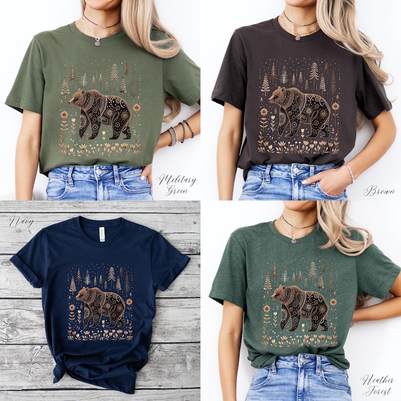 May include: Four t-shirts in military green, brown, navy, and heather forest colors. Each shirt features a detailed bear graphic with floral and tree elements. The shirts are displayed on a person.
