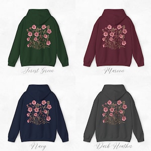 May include: Four different color hoodies with a floral design on the back. The colors are forest green, maroon, navy, and dark heather.