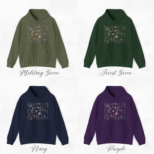 May include: Four hooded sweatshirts in different colors: military green, forest green, navy blue, and purple. Each sweatshirt features a floral print design on the front.