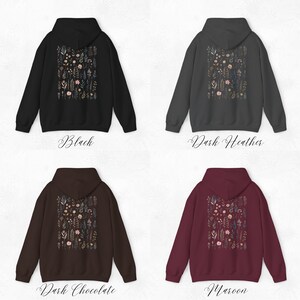 May include: Four different color hoodies with a floral print on the back. The colors are black, dark heather, dark chocolate, and maroon.