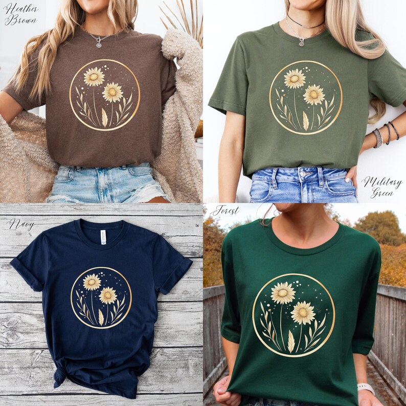 May include: Four t-shirts in different colors: heather brown, military green, navy, and forest green. Each shirt features a gold-colored circular design with two sunflowers and foliage. The shirts are short-sleeved and made of a soft material.