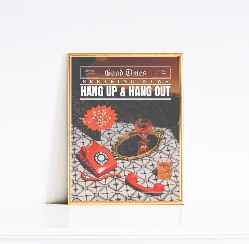 May include: A framed print with a vintage newspaper design featuring the text "Good Times Breaking News Hang Up & Hang Out". The image shows a red rotary phone, a glass of red liquid, and a glass of brown liquid on a tiled surface.