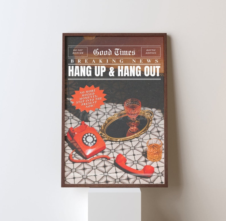 May include: A framed print with a vintage newspaper design. The headline reads "Good Times Breaking News Hang Up & Hang Out". The image features a red rotary phone, a glass of red wine, and a glass of whisky on a tiled surface.