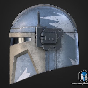 May include: A weathered, metallic helmet with a blue and silver color scheme. The helmet features a visor, a rectangular attachment, and white lightning bolt designs. The overall design suggests a futuristic or science fiction theme.
