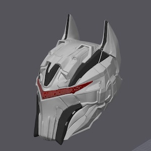 May include: A futuristic white helmet with black accents and a red visor. The helmet has a geometric design with pointed ear-like structures on top. The overall aesthetic suggests a sci-fi or cosplay theme.