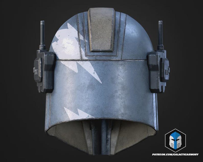 May include: A weathered, blue helmet with white lightning bolt designs. The helmet has a rectangular top section and two antenna-like structures on the sides. The design suggests a futuristic or sci-fi theme.