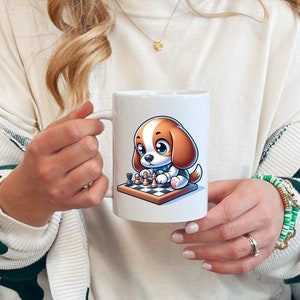 May include: White ceramic mug with a cartoon image of a brown and white dog playing chess. The dog is wearing a blue collar and is sitting on a white and black chessboard.