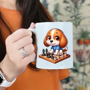 May include: White ceramic mug featuring a cartoon puppy playing chess. The puppy has brown and white fur and is wearing a blue shirt. The chess board has black and white pieces. The mug is held by a person.
