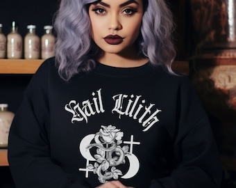 May include: Black sweatshirt with a white graphic print of a rose, snake, and crosses. The text "Hail Lilith" is printed in white above the graphic.