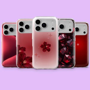May include: A collection of five phone cases in shades of red. Designs include a flower, geometric shapes, and a heart. The cases have clear edges and are displayed against a purple background.
