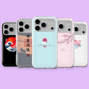 May include: A selection of phone cases with Japanese-inspired designs. The cases display images of a wave, Mount Fuji, cherry blossoms, and other traditional Japanese art. The cases are in various colours, including black, blue, and pink.