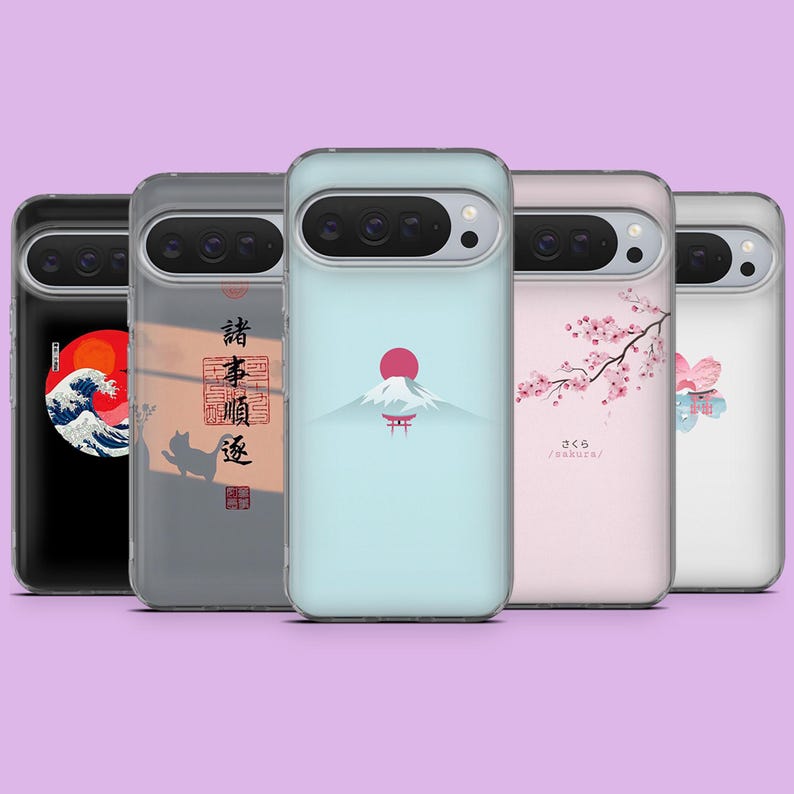 May include: A selection of phone cases with Japanese-inspired designs. The cases display illustrations of a wave, Mount Fuji with a red sun, cherry blossoms, and other Japanese motifs. The cases are in various colours, including black, grey, and light blue.