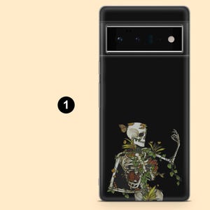 May include: Black phone case featuring a detailed illustration of a skeleton with floral and butterfly accents. The design includes a skull, rib cage, and limbs, with green leaves and colorful flowers. The case is for a smartphone.