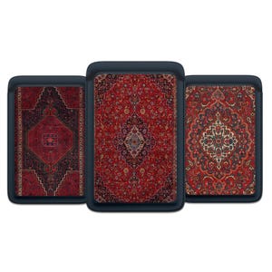 May include: Three rectangular cases with a navy blue border, each displaying a different Persian rug design. The rugs are mainly red with complex patterns in black, cream, and blue. The cases are likely for electronic devices.