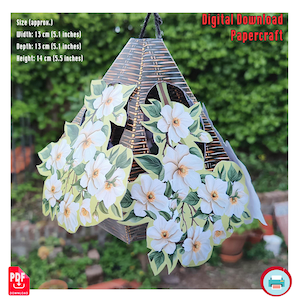 May include: A papercraft birdhouse with a brown and gold woven pattern, adorned with white flower cutouts and green leaves. The birdhouse is approximately 5.1 inches wide, 5.1 inches deep, and 5.5 inches high. The text "Digital Download Papercraft" is visible.