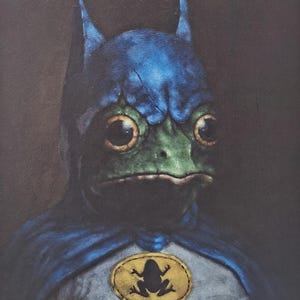May include: A painting of a frog wearing a blue and gray costume with a cape and a bat-like cowl. The frog has large, round eyes and a green face. A gold emblem with a frog silhouette is on the chest.